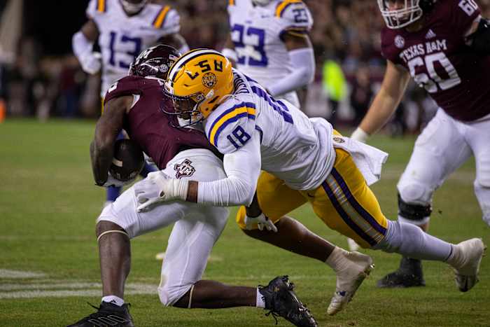 LSU Tigers defensive end BJ Ojulari (18) and Texas A&M Aggies running back Devon Achane (6) in action during the game between the Texas A&M Aggies and the LSU Tigers at Kyle Field.